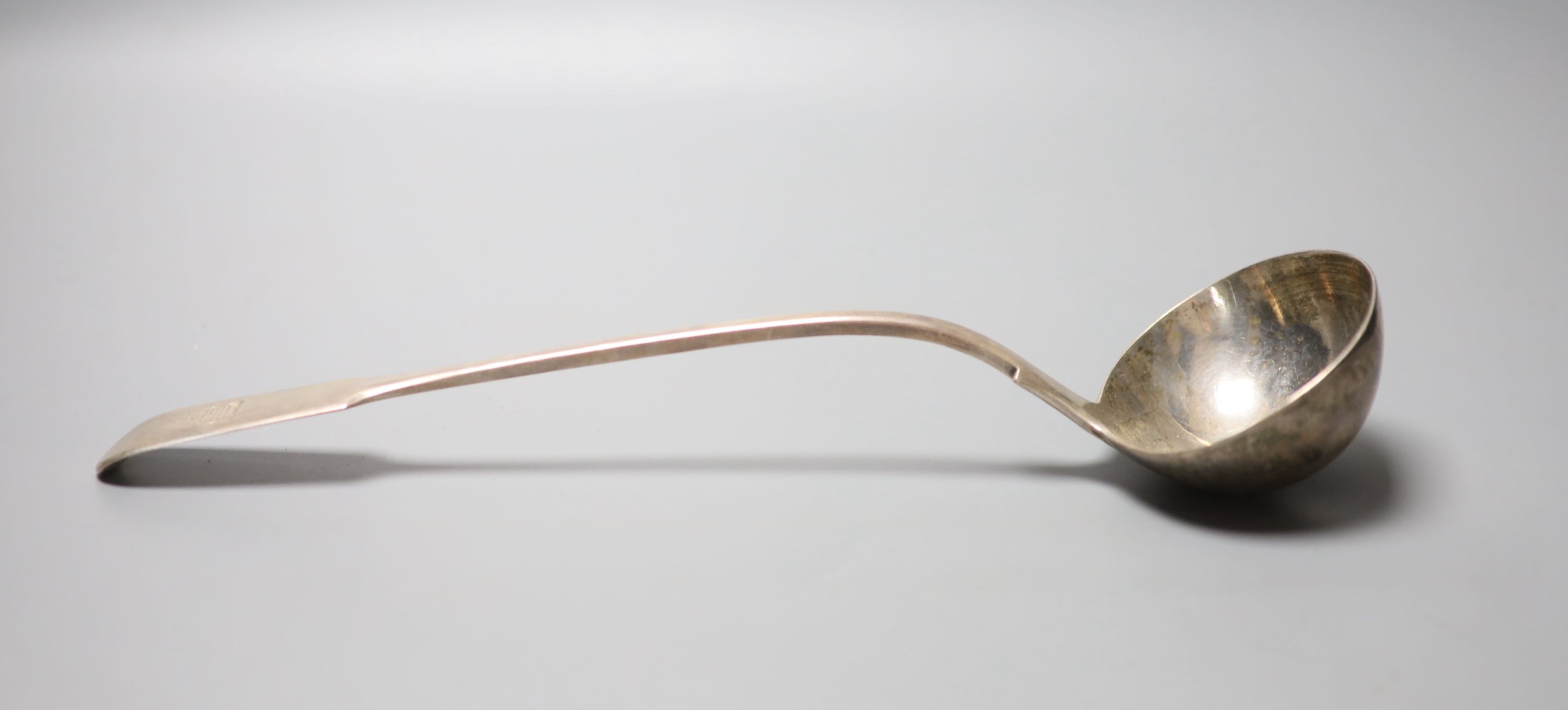 A Victorian silver fiddle pattern soup ladle, with engraved crest, William Smily, London 1862, 34.2cm, 9oz.